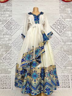 Beautiful Ethiopian and Eritrean Habeshan Dress. Stylish Menen, 100% Cotton We recommend hand washing and air drying to make it last longer. A low heating iron will also keep design and look. Beautiful Habeshan Dress |Ethiopian Traditional Dress|Eritrean Dress|Habesha Kemis|Zuria|Habesha Chiffon|Kemis Blue Ethiopian Dress, Habesha Traditional Dresses, Gold Habesha Kemis, Eritrean Traditional Dress, Ethiopia Traditional Clothing, Eritrean Women Traditional Dresses, Eritrean Zuria Dresses, Habesha Kemis For Graduation, Habesha Dress Design