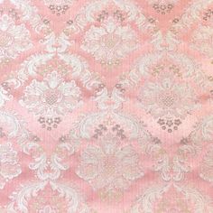 an old pink and white wallpaper with floral designs