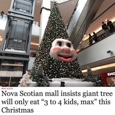 a giant christmas tree in the middle of a mall