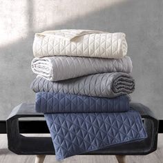 four blankets stacked on top of each other