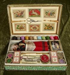 an old sewing box is filled with needle and thread spools, scissors, and other items