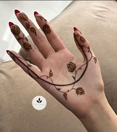 a woman's hand with flowers on it