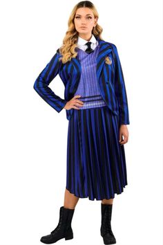 a woman wearing a blue and black striped dress with long sleeves, pleated skirt and boots