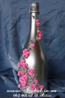 a silver bottle with pink flowers on it