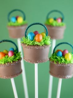 three cake pops decorated with grass and eggs