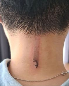 a person with a small tattoo on their neck and behind the neck is an arrow