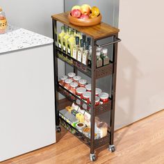 a kitchen cart with food on it next to a refrigerator