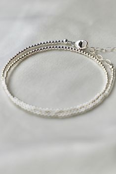 Our double wrap bracelet is one of our number one best selling bracelets. The petite double wrap beaded bracelet features a sterling silver 2mm bead that can be worn as a bracelet or a single layer choker necklace.Materials: Sterling silver beads Length: Measures an adjustable 14-15 inch length with a 2 inch extender SKU: B1182 Materials+Care Silver Double Strand Bracelet, Minimalist Silver Bracelets With Tiny Beads, Double Strand Sterling Silver Bracelet For Gift, Sterling Silver Double Strand Bracelet Gift, Dainty Silver Bracelets With Tiny Beads, Sterling Silver Bracelets With Ball Chain, Sterling Silver Bracelets With Ball Chain And Round Beads, Tiny Beads Multi-strand Bracelet, Minimalist Beaded Bracelets With Ball Chain