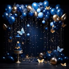 a cake surrounded by balloons and butterflies on a black background with gold confetti