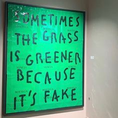 there is a green sign that says sometimes the grass is greener because it's fake