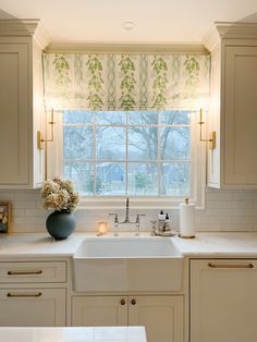 a kitchen with a sink, window and countertop in it's center area