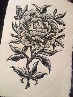 a black and white drawing of a flower on a piece of paper that has been drawn