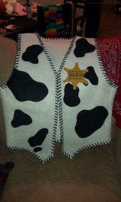 two vests made to look like cows with black and white cow spots on them