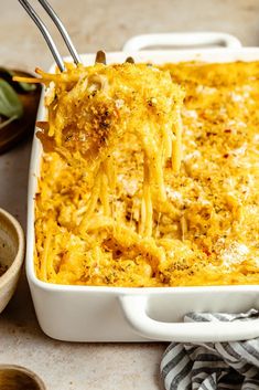 a casserole dish with cheese being lifted from it