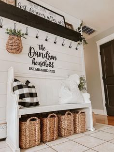 a white bench with baskets on it next to a black and white sign that says the davidson house