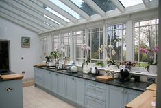 a kitchen filled with lots of counter top space next to a stove top oven and sink