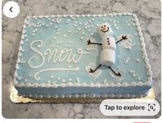 a frosted cake with a snowman on it and the words let it snow