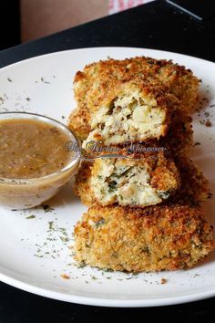 some food on a white plate with a dipping sauce