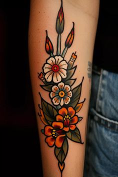 a woman's arm with flowers and candles tattooed on the side of her leg