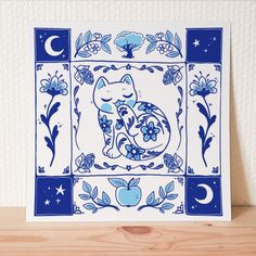 a blue and white card with an image of a cat sitting on top of it