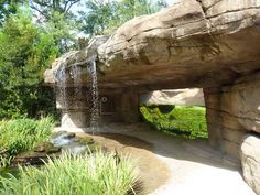 a large rock formation with water coming out of it