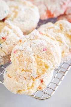 several sugar cookies are cooling on a wire rack with powdered sugar sprinkles