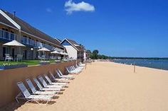 the beach is lined with lawn chairs and umbrellas