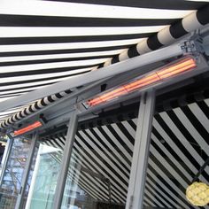 the inside of a building with black and white stripes on it's walls, including an electric heater