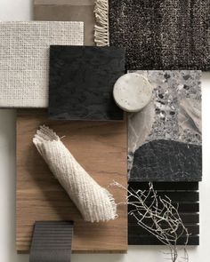 an assortment of different materials are arranged on a table with white and black accents, including wood