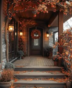 the front porch is decorated with fall leaves and wreaths