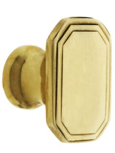 an antique brass door knob with a white background