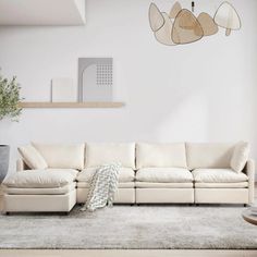 a living room with a white couch and rug