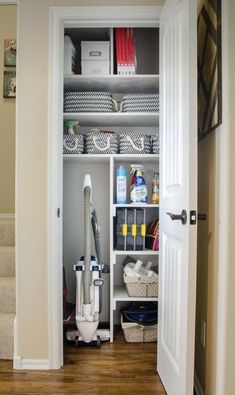 an open closet with various items on the shelves and in front of it is a white door