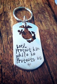 a keychain with a message on it that says lord protect him while he protects us