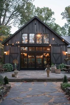 big windows on a black Barndominium Industrial Barndominium Ideas, Barndo Black, Rustic Barndominium Ideas Exterior, Interior Design Barndominium, Barn Exterior Colors, Modern Country House Exterior, Industrial Farmhouse Exterior, Barn Ideas Buildings, Modern Barn House Interior