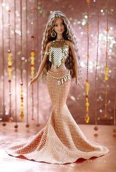 a barbie doll is wearing a gold outfit