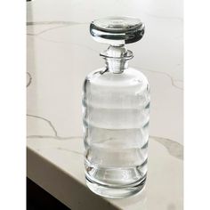 an empty glass bottle sitting on top of a counter