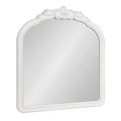 a white mirror with an ornate frame