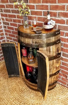 a wooden barrel table with liquor bottles on it