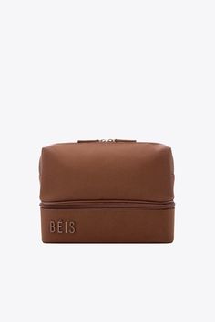 a brown cosmetic bag with the word beiss on it