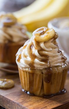 cupcakes with frosting and bananas on a cutting board