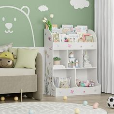 a child's room with green walls and white furniture