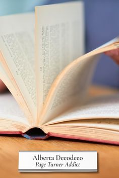 an open book sitting on top of a wooden table