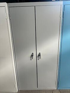 two metal cupboards are next to each other