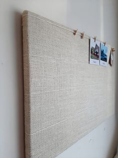 a close up of a bed with pictures on the headboard and pins pinned to it