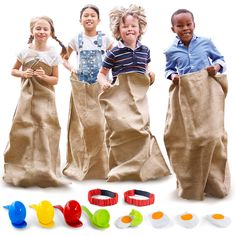 three children are standing in jumbo sacks with their hands on the pants and one child is holding an object