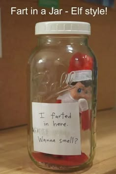 a glass jar with a santa clause on it and a note attached to the lid