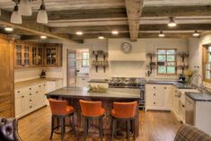 a large kitchen with an island in the middle and lots of counter space on each side