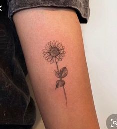 a small sunflower tattoo on the right thigh