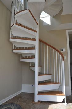 a white spiral staircase in a house